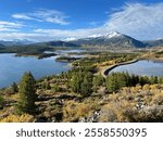 Serene view of Old Dillon Reservoir, Dillon, Colorado. Scenic mountain landscape with calm water reflecting surrounding peaks and lush greenery. Ideal for nature and travel themes