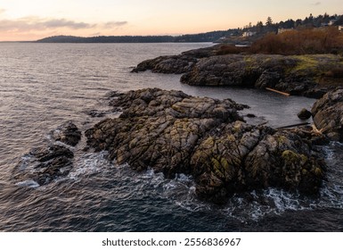 Serene view of a rocky coastline at dawn near Victoria on Vancouver Island. The gentle waves and distant horizon create a peaceful and tranquil atmosphere, ideal for nature and landscape enthusiasts. - Powered by Shutterstock