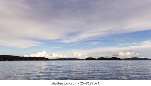 A serene view of Vancouver Island's coastline in British Columbia, Canada. The calm ocean and expansive sky create a peaceful and picturesque scene perfect for relaxation and inspiration. - Powered by Shutterstock