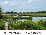 Serene water of the Bass River and lush green salt marsh in Yarmouth, Cape Cod