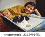 Serene woman on a bed with a black and white cat sitting on a skycar