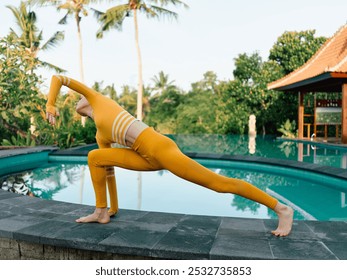 Serene woman in yellow practicing yoga poolside in bali, embracing tranquility and inner peace - Powered by Shutterstock