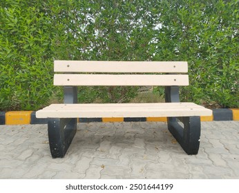 Serene wooden bench nestled among lush greenery, inviting relaxation and contemplation in a peaceful, idyllic park setting with nature's beauty - Powered by Shutterstock