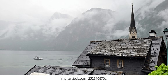 A serene wooden cabin nestled by a misty lakeside, surrounded by lush greenery and towering mountains shrouded in clouds. The tranquil atmosphere evokes a sense of peace and solitude. The rustic charm - Powered by Shutterstock