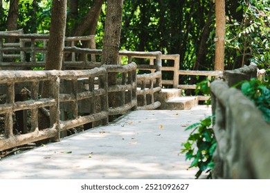 A serene wooden pathway winding through lush greenery, surrounded by tall trees and vibrant foliage, evoking a sense of tranquility and connection with nature. - Powered by Shutterstock