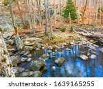 Serene, zen, forest landscape with rocks and water for autumnal nature hike in the woods at Cunningham Falls State Park in the Catoctin Mountains, Maryland