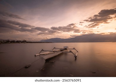 Serenity at Dusk: A Tranquil Canoe Resting on a Calm Lake Under a Pastel Sky - Powered by Shutterstock