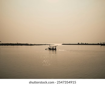 Serenity engulfs the scene with fishing boats silhouetted against a vibrant red sunset over tranquil waters, creating a peaceful and dramatic atmosphere. - Powered by Shutterstock