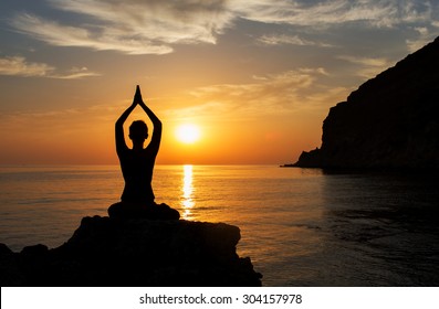 Serenity And Yoga Practicing At Sunset, Meditation.Twilight In Goa State,India