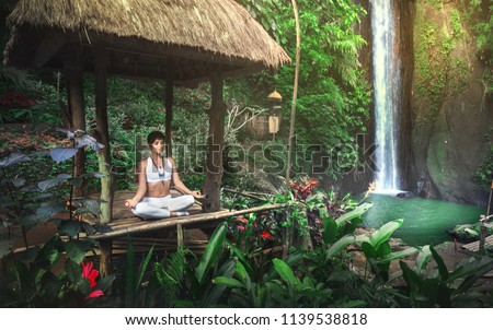 Serenity and yoga practicing at waterfall,Bali,Imdonesia

