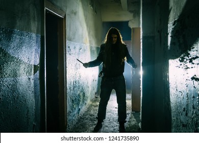 Serial Killer Maniac With Knife In Dark Abandoned Building. Maniac Thriller Concept  