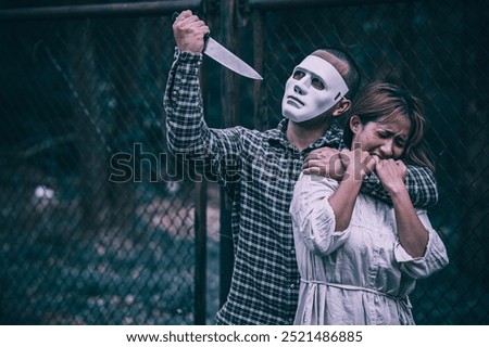 A serial killer scene is about to kill an Asian woman,concept thriller scene,Halloween festival