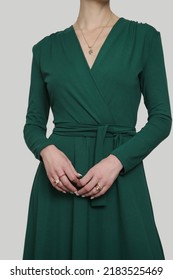 Serie Of Studio Photos Of Young Female Model In Emerald Green Wrap Dress. 