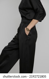 Serie Of Studio Photos Of Young Female Model Wearing All Black Classic Basic Outfit, Silk Satin Blouse And Wide Legged Trousers.	