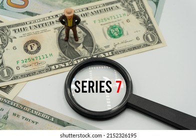 Series 7.Magnifying glass showing the words.Background of banknotes and coins.basic concepts of finance.Business theme.Financial terms. - Shutterstock ID 2152326195