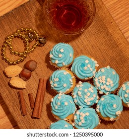 Series of Blue Frosted Cupcakes arranged with nuts, tea and spices - Powered by Shutterstock