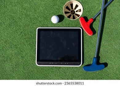 Series with golf clubs, digital tablet and balls on artificial grass. - Shutterstock ID 2365538011