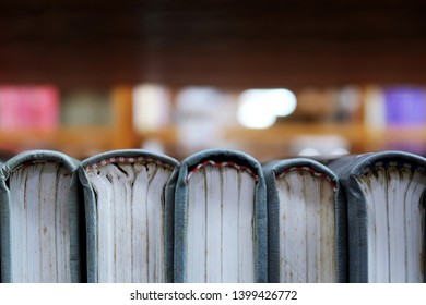 Series Of  Hard Cover Binding Books Spine On Library Shelf  - With Blurred Background For Copy Space. Concept Of Academic Student Reading / Reference Researching.