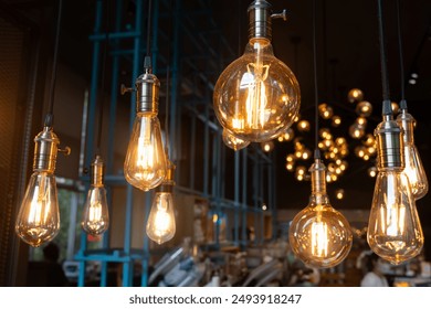 A series of light bulbs hanging from the ceiling, some of which are lit up. The bulbs are of different sizes and colors, creating a warm and inviting atmosphere - Powered by Shutterstock