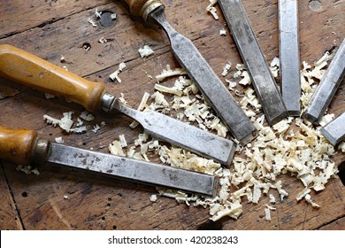series of many sharp steel blades many chisels and sawdust chippings in Workbench