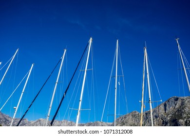 A Series Of Masts Of Multiple Sailboats