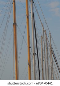 A Series Of Masts Of Multiple Sailboats.