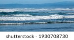 A series of multiple turbulent waves roll on shore at Moss Landing State Beach, along the Monterey Bay of the central coast of California. 