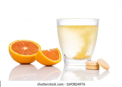 Series Of Orange Flavored Vitamin C Effervescent Tablet Dropped And Dissolve In Glass Of Water On White Background