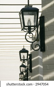 Series Of Overhead Light Fixtures In Sunlit Arcade