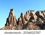 A series of rocky desert cliff towers