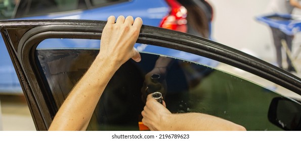 A Series Of Tinting Car Windows. Installation Of Tinting Film On The Car Glass. Specialist In The Installation Of Tinting Film In The Process Of Work.