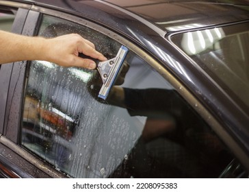 A Series Of Tinting Car Windows. Installation Of Tinting Film On The Car Glass. Specialist In The Installation Of Tinting Film In The Process Of Work.