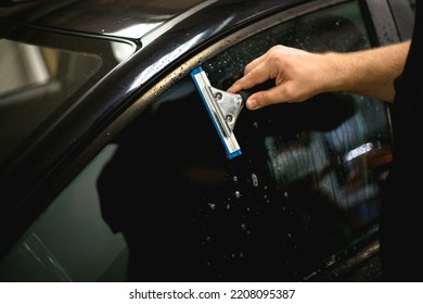 A Series Of Tinting Car Windows. Installation Of Tinting Film On The Car Glass. Specialist In The Installation Of Tinting Film In The Process Of Work.