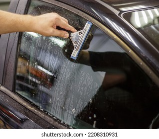 A Series Of Tinting Car Windows. Installation Of Tinting Film On The Car Glass. Specialist In The Installation Of Tinting Film In The Process Of Work.