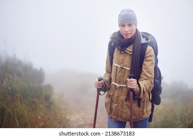 Serious About Hiking. Portrait Of A Young Woman Hiking Along A Trail On An Overcast Day.