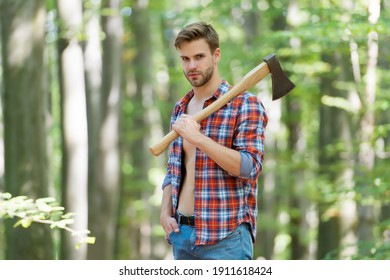 serious about. sexy guy wear unbuttoned shirt in forest. male power and energy. firewood at the campsite. camping and hiking. outdoor activity. strong man with ax. woodcutter. ranch man carry axe.