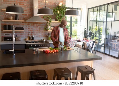 Serious African American Senior Man Cooking In Kitchen. Retirement Lifestyle, Leisure And Spending Time At Home.