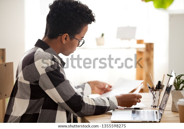 Serious African American Woman Reading Documents Stock Photo - 