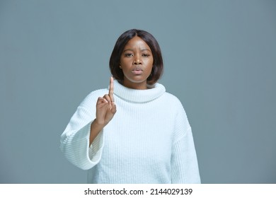 Serious african american woman warning by admonishing gesture, raised finger up, saying no, be careful, giving advice - Shutterstock ID 2144029139
