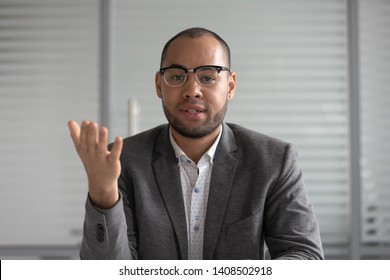 Serious African Businessman Entrepreneur In Suit Talking To Camera, Mixed Race Coach Webinar Speaker Teacher Trainer Shooting Vlog Online Business Training Look At Webcam Make Conference Video Call