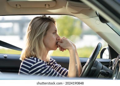 Serious anxious female driving car. Adult woman of middle age pensive sad thinking on important decision while waiting in traffic jam. Depressed or worried vehicle driver in automobile feeling bad