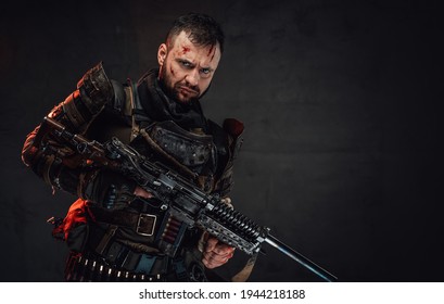 Serious Apocalyptic Guy With Shotgun Poses In Dark Background