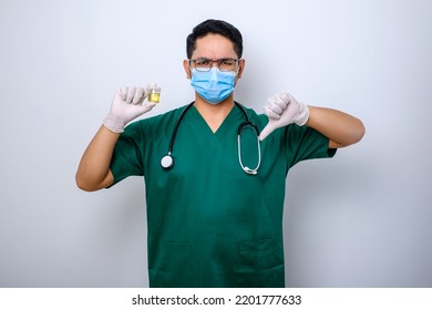 Serious Asian Doctor Holding Urine Pot While Showing Thumb Down, Showing Bad Result Test Standing Over White Background