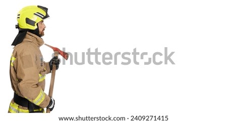 Serious bearded firefighter holding axe tool. Side view of focused male fireman with wooden hatchet looking on copy place beside, isolated on white background. Job, equipment, tool concept.