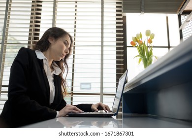 serious beautiful woman looking at laptop computer, thinking new project
 - Shutterstock ID 1671867301
