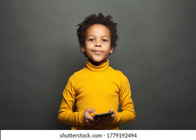 Serious Black Child Using Smartphone