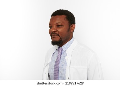 Serious Black Doctor Man With Small Beard In White Coat Bright Shirt Isolated On White Background. Adult  African American Physician Therapist Portrait, Attractive Practitioner Family Doctor