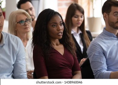 Serious Black Female Professional Ask Question At Group Seminar Lecture Event, Confident African Business Woman Training Conference Participant Sit On Chair Talking At Corporate Meeting Workshop