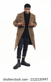 Serious Black Man Modeling Brown Coat White Background - Full Shot. High-quality Photo