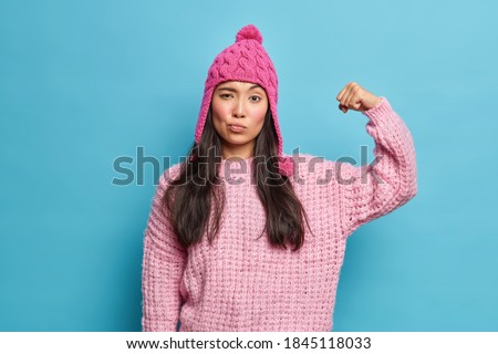 Similar – Image, Stock Photo Full body portrait of a young woman standing barefoot with long legs in a leopard print top and hot pants against a concrete wall looking challengingly at the camera